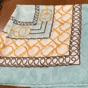 34”x34” silk Carlisle scarf. Teal, gold metal looking embossed scarf.
